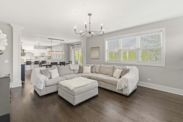 15175 Rodao Ln, Orland Park, IL 60467 - living area with decorative columns, a chandelier, dark wood-style floors, and baseboards
