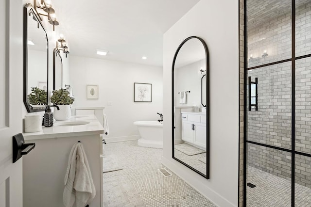 15175 Rodao Ln, Orland Park, IL 60467 - full bathroom featuring a stall shower, a soaking tub, two vanities, baseboards, and tile patterned floors