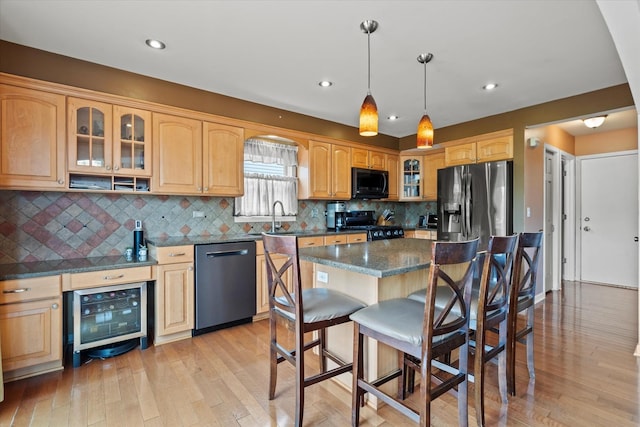 638 E Princeton Ct, Round Lake Beach, IL 60073 - kitchen with black appliances, beverage cooler, a kitchen bar, glass insert cabinets, and light wood-type flooring