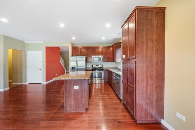 3471 Birch Ln, Naperville, IL 60564 - kitchen with stainless steel appliances, wood finished floors, a breakfast bar, a center island, and light stone counters