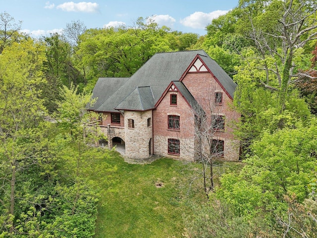 557 Signal Hill Rd, North Barrington, IL 60010 - view of front facade featuring stone siding, a shingled roof, a front yard, and a forest view
