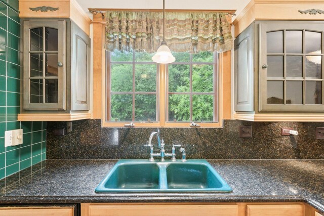 557 Signal Hill Rd, North Barrington, IL 60010 - kitchen with a sink, glass insert cabinets, dark countertops, tasteful backsplash, and plenty of natural light
