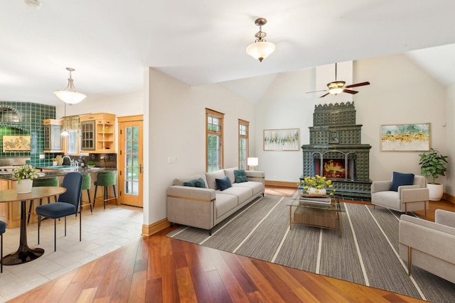 557 Signal Hill Rd, North Barrington, IL 60010 - living room featuring lofted ceiling, a fireplace, ceiling fan, wood finished floors, and baseboards