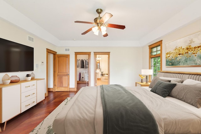 557 Signal Hill Rd, North Barrington, IL 60010 - bedroom with dark wood-style floors, a walk in closet, a ceiling fan, ensuite bath, and a tray ceiling