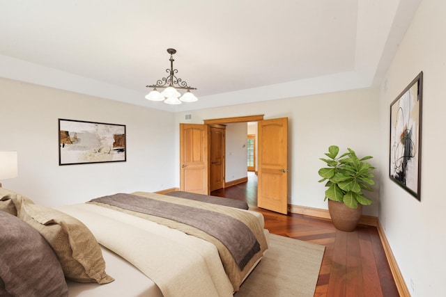 557 Signal Hill Rd, North Barrington, IL 60010 - bedroom with dark wood-style floors, baseboards, a chandelier, and a raised ceiling