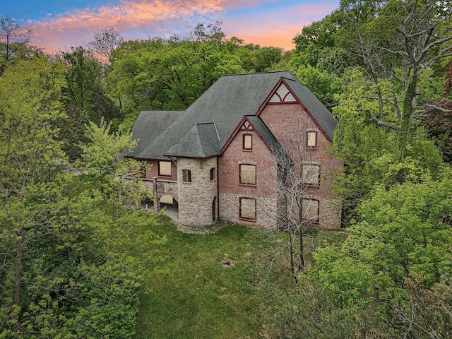 557 Signal Hill Rd, North Barrington, IL 60010 - view of property exterior with stone siding, a shingled roof, a yard, and a forest view
