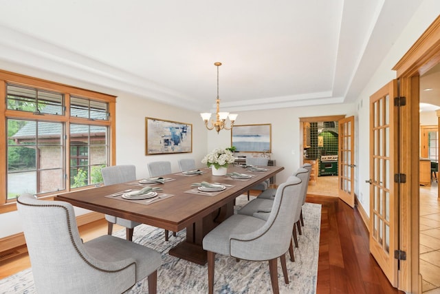 557 Signal Hill Rd, North Barrington, IL 60010 - dining space with a raised ceiling, a chandelier, french doors, wood finished floors, and baseboards