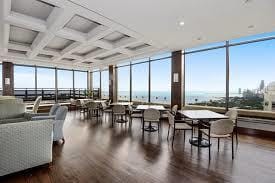 2650 N Lakeview Ave Unit 3505, Chicago, IL 60614 - dining room featuring floor to ceiling windows, wood finished floors, and beam ceiling