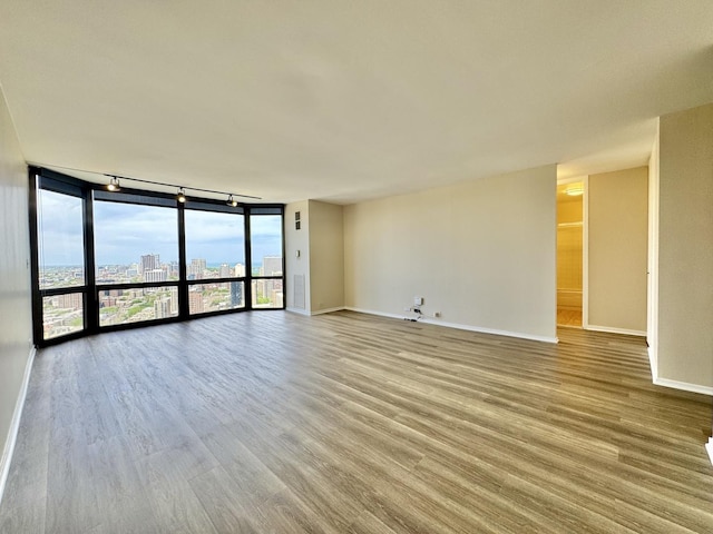 2650 N Lakeview Ave Unit 3505, Chicago, IL 60614 - spare room with wood finished floors, baseboards, rail lighting, and a wall of windows