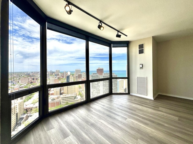 2650 N Lakeview Ave Unit 3505, Chicago, IL 60614 - unfurnished room featuring track lighting, a view of city, baseboards, floor to ceiling windows, and wood finished floors