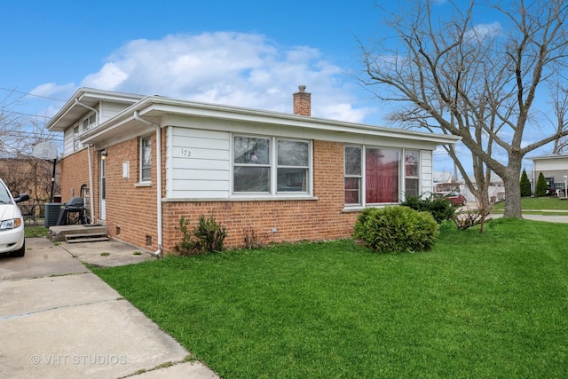 172 Strieff Ave, Chicago Heights, IL 60411 - view of side of home featuring brick siding, a chimney, a lawn, crawl space, and central AC unit