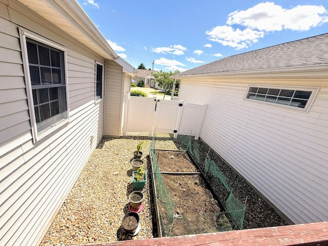 72 Astoria Way, Bloomington, IL 61704 - view of yard with a vegetable garden, fence, and a gate