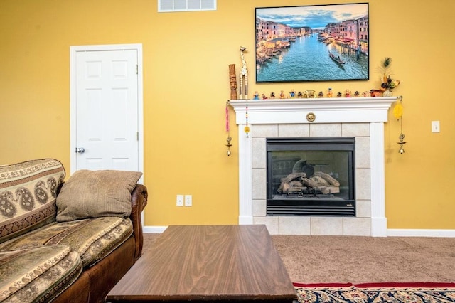 72 Astoria Way, Bloomington, IL 61704 - living room featuring a tile fireplace, baseboards, and carpet