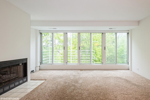 2525 Wellington Ct Unit 307, Evanston, IL 60201 - unfurnished living room featuring light carpet and a fireplace with flush hearth