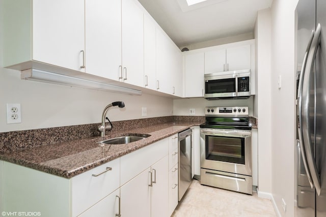 2525 Wellington Ct Unit 307, Evanston, IL 60201 - kitchen featuring appliances with stainless steel finishes, white cabinets, and dark stone counters