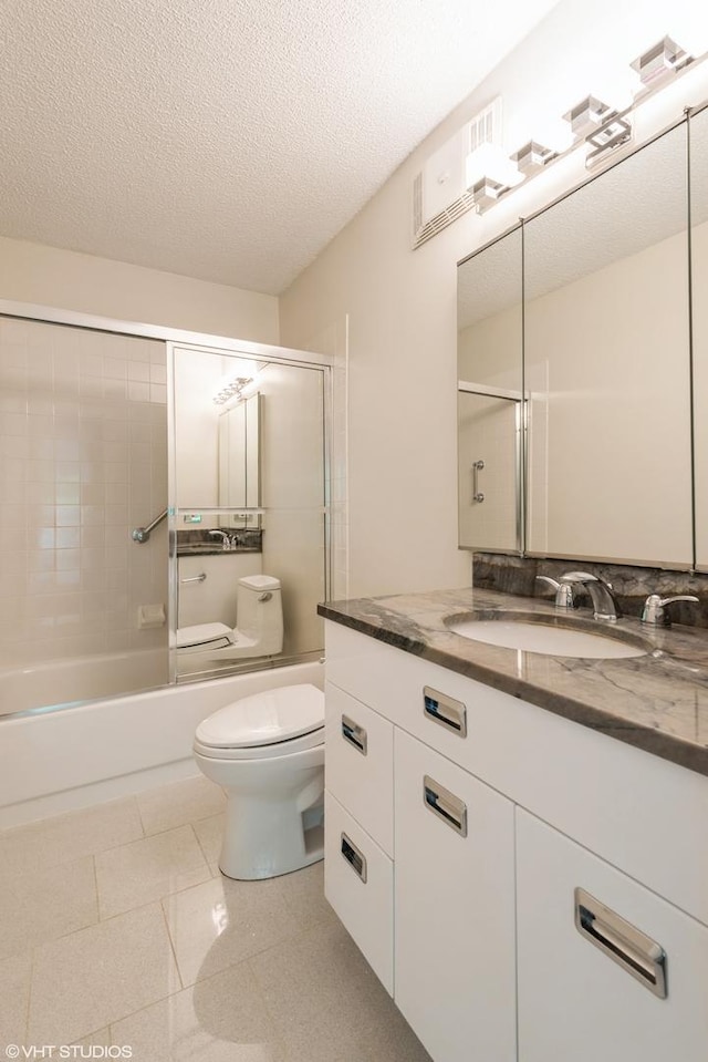2525 Wellington Ct Unit 307, Evanston, IL 60201 - bathroom with vanity, combined bath / shower with glass door, and a textured ceiling