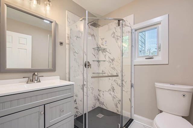 full bath featuring toilet, vanity, and a marble finish shower