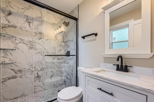 full bathroom with a shower stall, toilet, and vanity