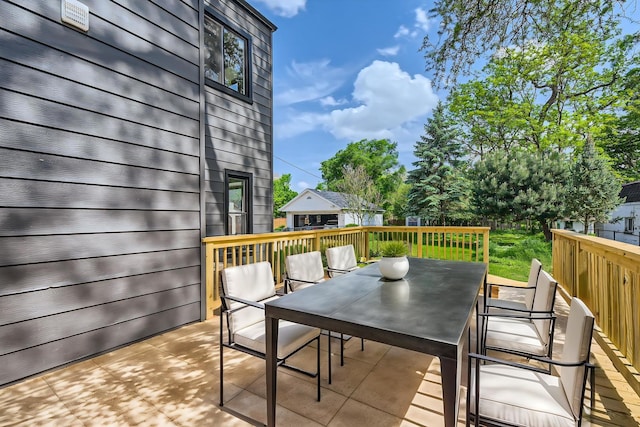 wooden terrace featuring outdoor dining space