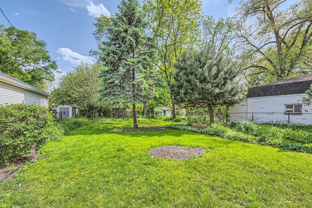 view of grassy yard with a storage shed and an outdoor structure