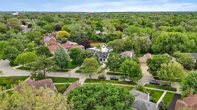aerial perspective of suburban area featuring a heavily wooded area