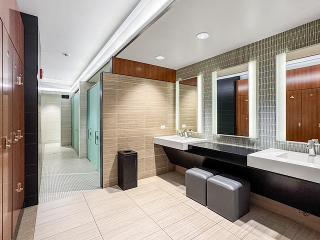 175 E Delaware Pl Unit 7511, Chicago, IL 60611 - bathroom featuring tile walls, tile patterned flooring, a shower stall, and double vanity