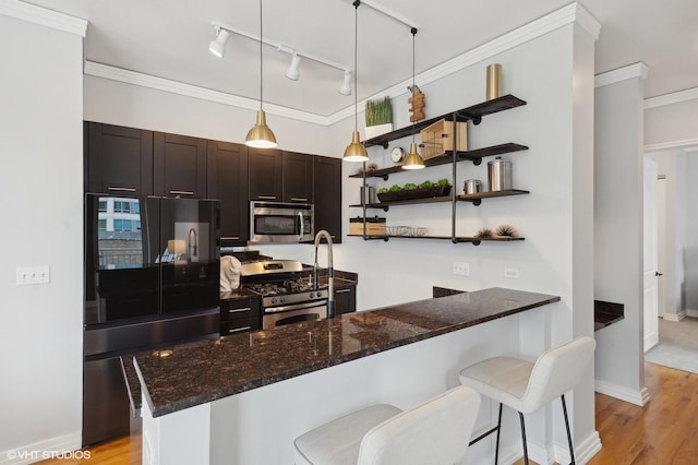170 W Polk St Unit 1408, Chicago, IL 60605 - kitchen with appliances with stainless steel finishes, dark stone countertops, a peninsula, open shelves, and crown molding