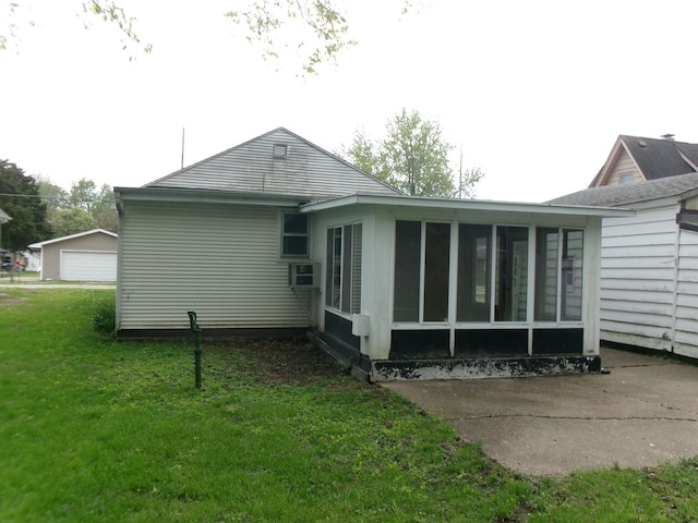 827 Canal St, Marseilles, IL 61341 - rear view of property featuring a sunroom, a lawn, a detached garage, and cooling unit
