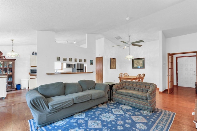 2805 Susan Stone Dr, Urbana, IL 61802 - living room with wood finished floors, ceiling fan, lofted ceiling, and a textured ceiling