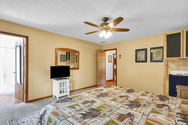 2805 Susan Stone Dr, Urbana, IL 61802 - carpeted bedroom with a textured ceiling, baseboards, ceiling fan, and connected bathroom