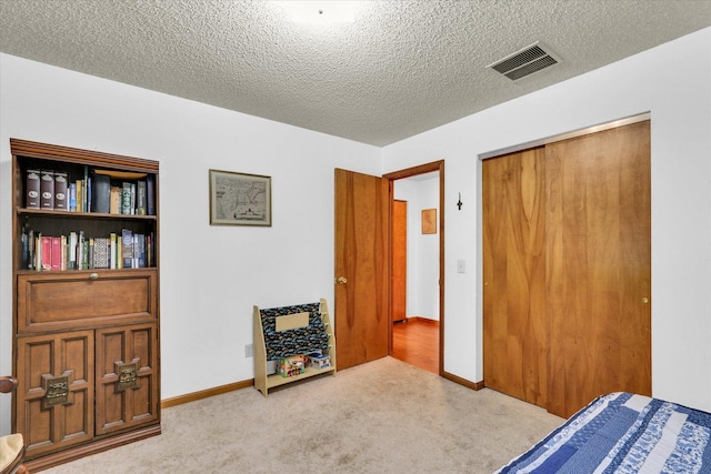 2805 Susan Stone Dr, Urbana, IL 61802 - carpeted bedroom with a textured ceiling, a closet, and baseboards