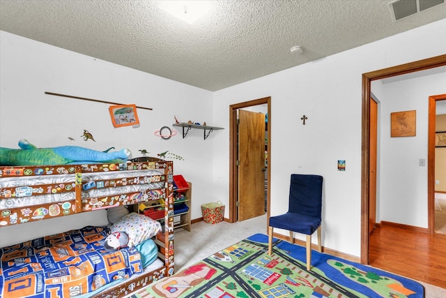 2805 Susan Stone Dr, Urbana, IL 61802 - bedroom with a textured ceiling, baseboards, and wood finished floors