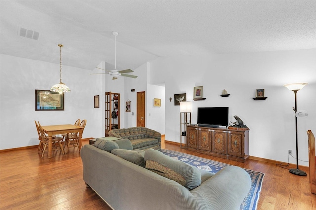 2805 Susan Stone Dr, Urbana, IL 61802 - living room featuring vaulted ceiling, a ceiling fan, wood finished floors, and baseboards
