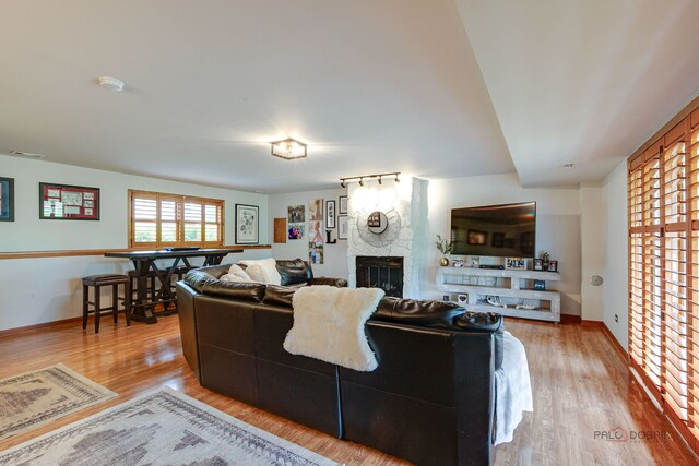 6316 Lake Shore Dr, Cary, IL 60013 - living room with a fireplace, wood finished floors, and baseboards