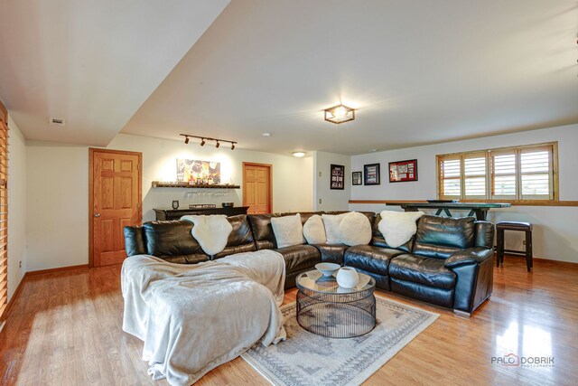 6316 Lake Shore Dr, Cary, IL 60013 - living room with light wood finished floors, baseboards, and rail lighting