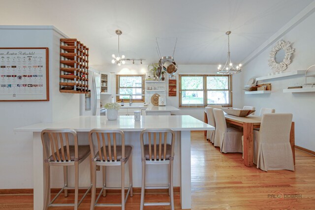 6316 Lake Shore Dr, Cary, IL 60013 - kitchen with a chandelier, light wood-type flooring, decorative light fixtures, and white fridge with ice dispenser