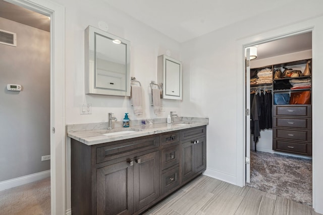 4532 Douglas Rd, Downers Grove, IL 60515 - bathroom featuring double vanity, a spacious closet, and baseboards