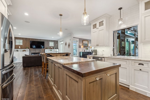 4532 Douglas Rd, Downers Grove, IL 60515 - kitchen with appliances with stainless steel finishes, a center island, open floor plan, dark wood finished floors, and ornamental molding