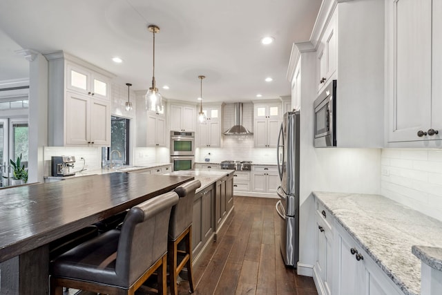4532 Douglas Rd, Downers Grove, IL 60515 - kitchen with wall chimney exhaust hood, appliances with stainless steel finishes, decorative backsplash, a sink, and recessed lighting