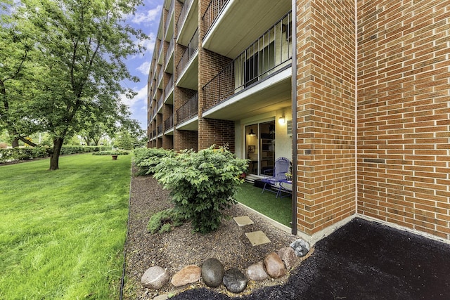 255 S W Ave Unit 101, Elmhurst, IL 60126 - view of exterior entry with brick siding and a yard