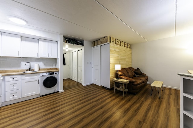 255 S W Ave Unit 101, Elmhurst, IL 60126 - kitchen featuring washer / clothes dryer, light countertops, white cabinetry, a sink, and tasteful backsplash