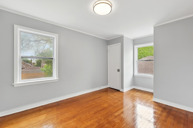 12137 S Perry Ave, Chicago, IL 60628 - empty room featuring crown molding, baseboards, and wood finished floors