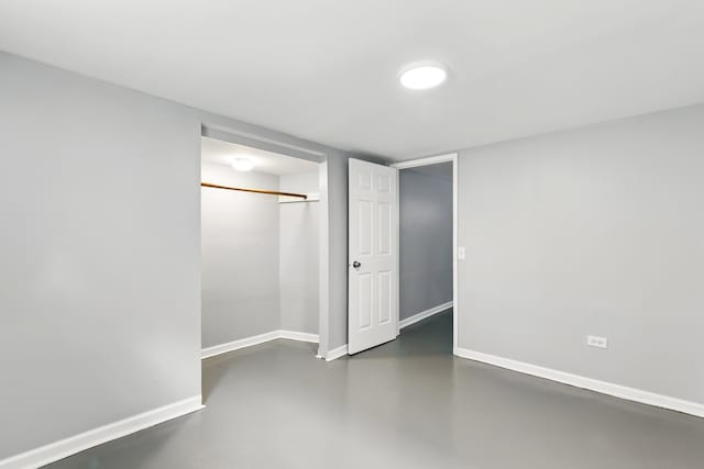 12137 S Perry Ave, Chicago, IL 60628 - unfurnished bedroom featuring concrete floors, baseboards, and a closet
