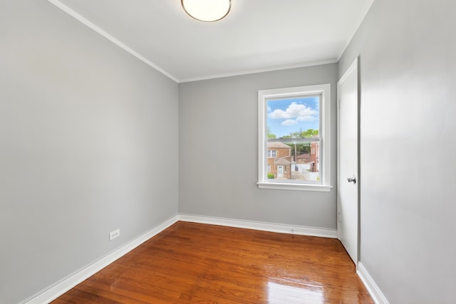 12137 S Perry Ave, Chicago, IL 60628 - empty room featuring wood finished floors, baseboards, and crown molding