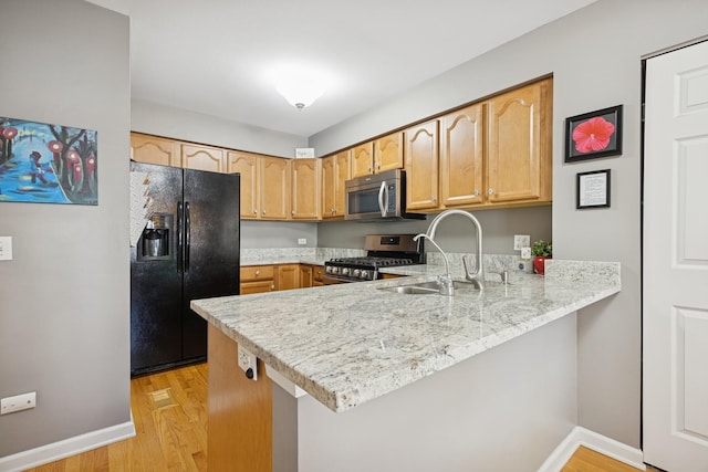 2618 Smith St, Rolling Meadows, IL 60008 - kitchen featuring appliances with stainless steel finishes, a sink, a peninsula, and baseboards
