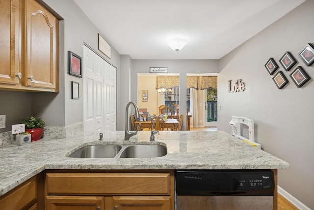 2618 Smith St, Rolling Meadows, IL 60008 - kitchen with dishwashing machine, a sink, a peninsula, light stone countertops, and wood finished floors