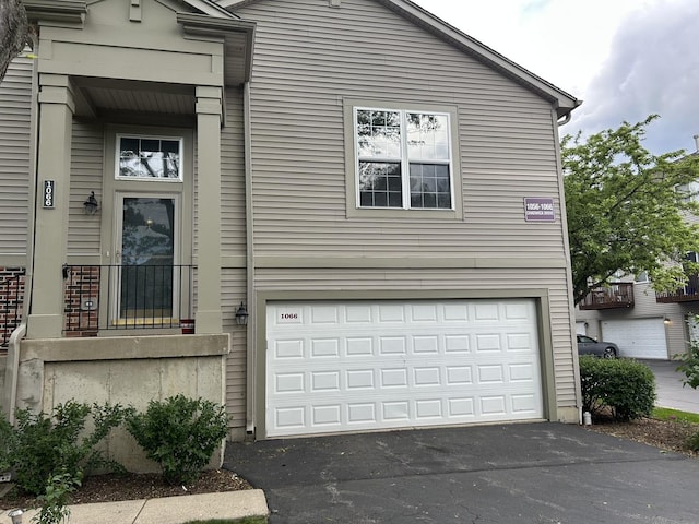 view of front of property with a garage and asphalt driveway