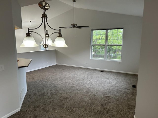 empty room with dark carpet, vaulted ceiling, a ceiling fan, and baseboards
