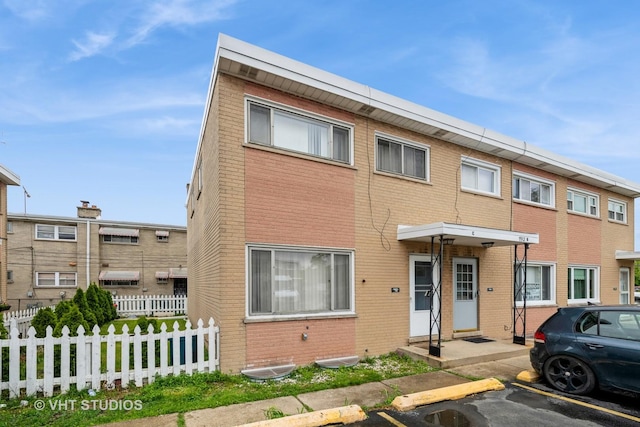7912 W Lawrence Ave Unit C, Norridge, IL 60706 - view of front of house featuring uncovered parking and brick siding