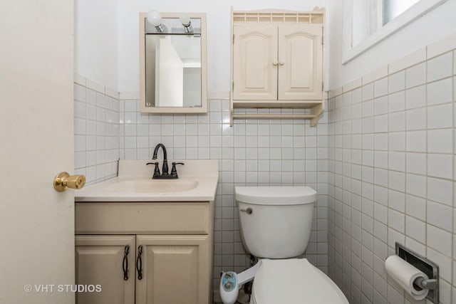 7912 W Lawrence Ave Unit C, Norridge, IL 60706 - half bathroom featuring tile walls, toilet, vanity, and wainscoting